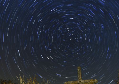 Star trails over the cross